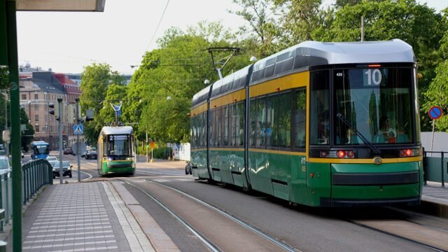 Two trams on a sunny street in Helsinki