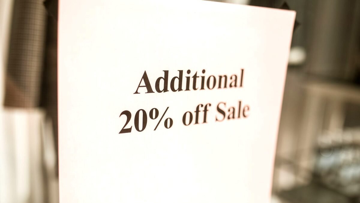 Close-up of a shop sign offering an extra 20 percent discount
