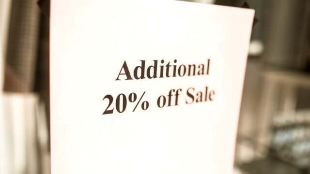 Close-up of a shop sign offering an extra 20 percent discount