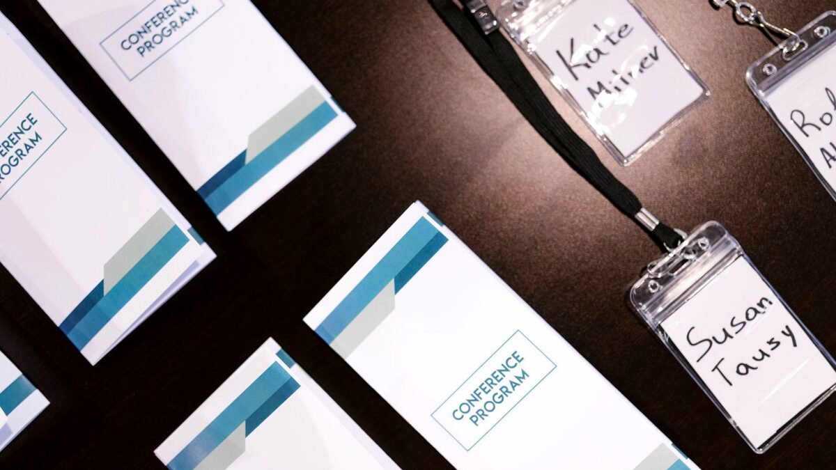 Name badges and printed programmes laid out on a table before an event