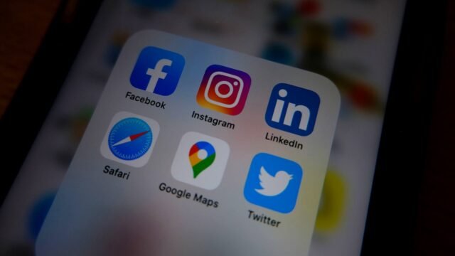 Close-up of a smartphone home screen with social media app icons