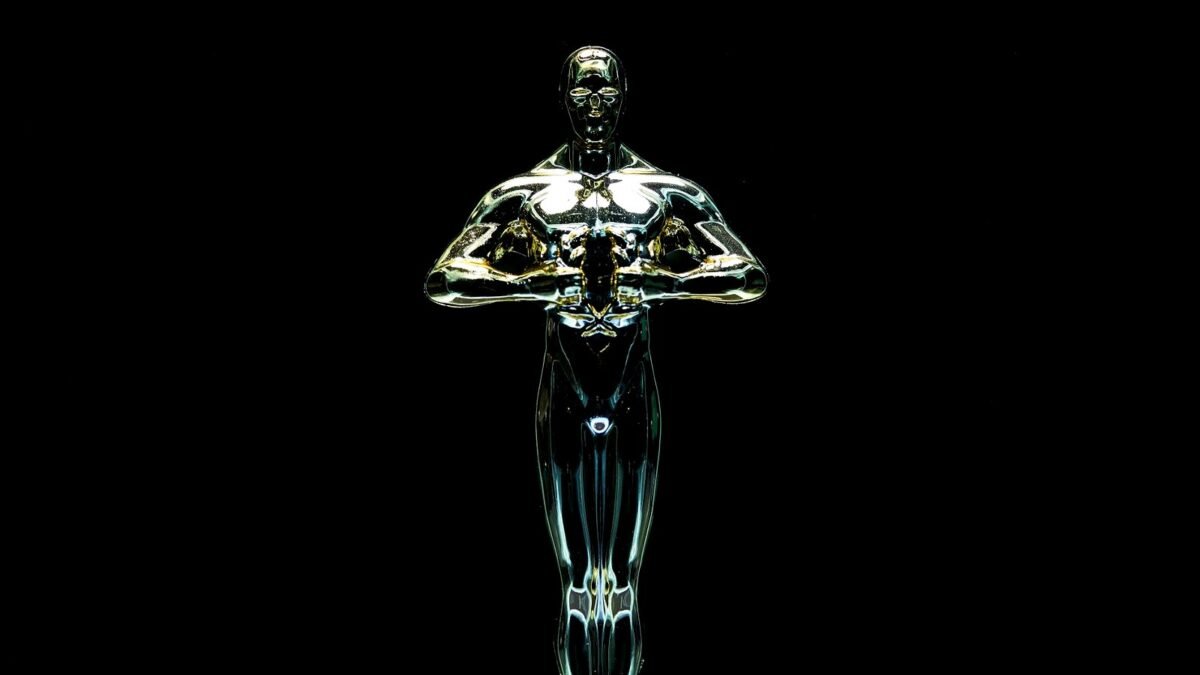 Golden trophy statue against a black background