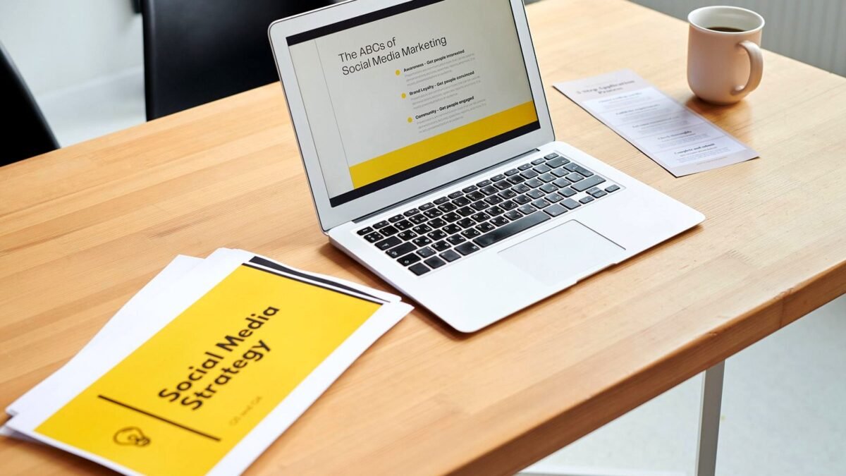 A laptop screen shows a social media marketing dashboard