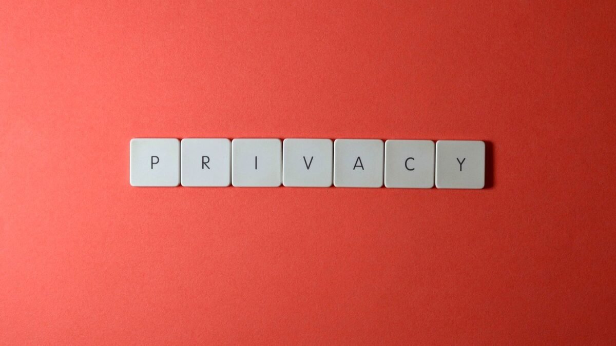 Letter tiles spelling the word privacy on a red background