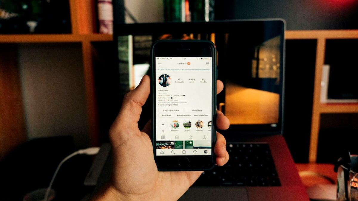 Hand holding a smartphone with the Instagram app open