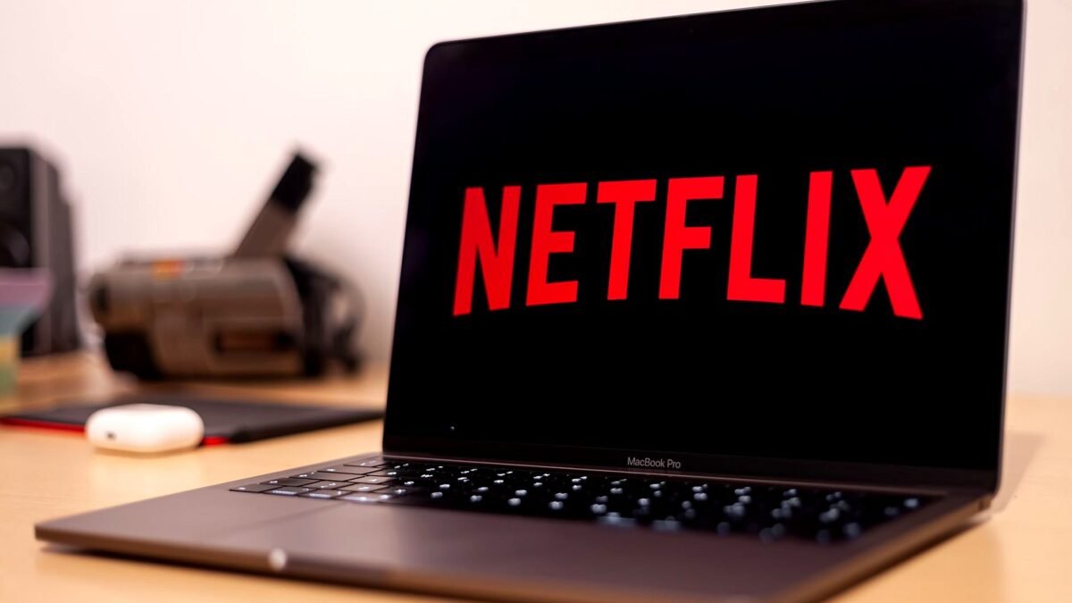 Laptop on a desk with the Netflix home screen open