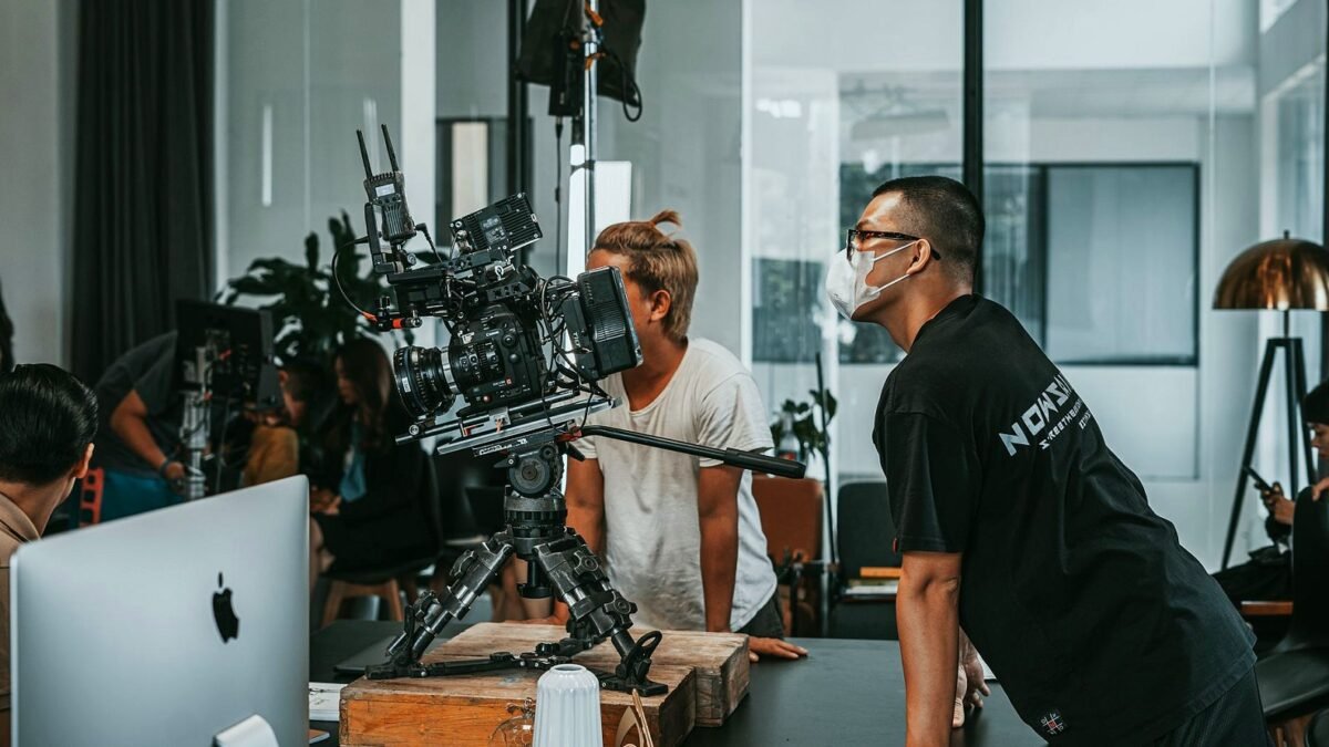 Film crew working with cameras and lights in a bright production studio