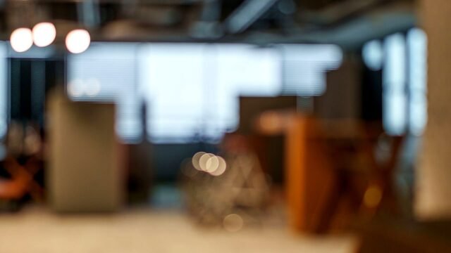 Defocused open-plan office with soft light and empty desks