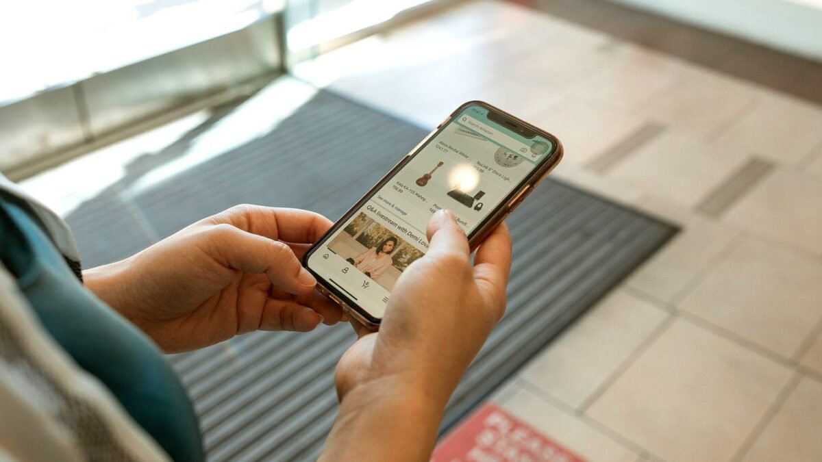 Hands holding a smartphone with an online shopping app open